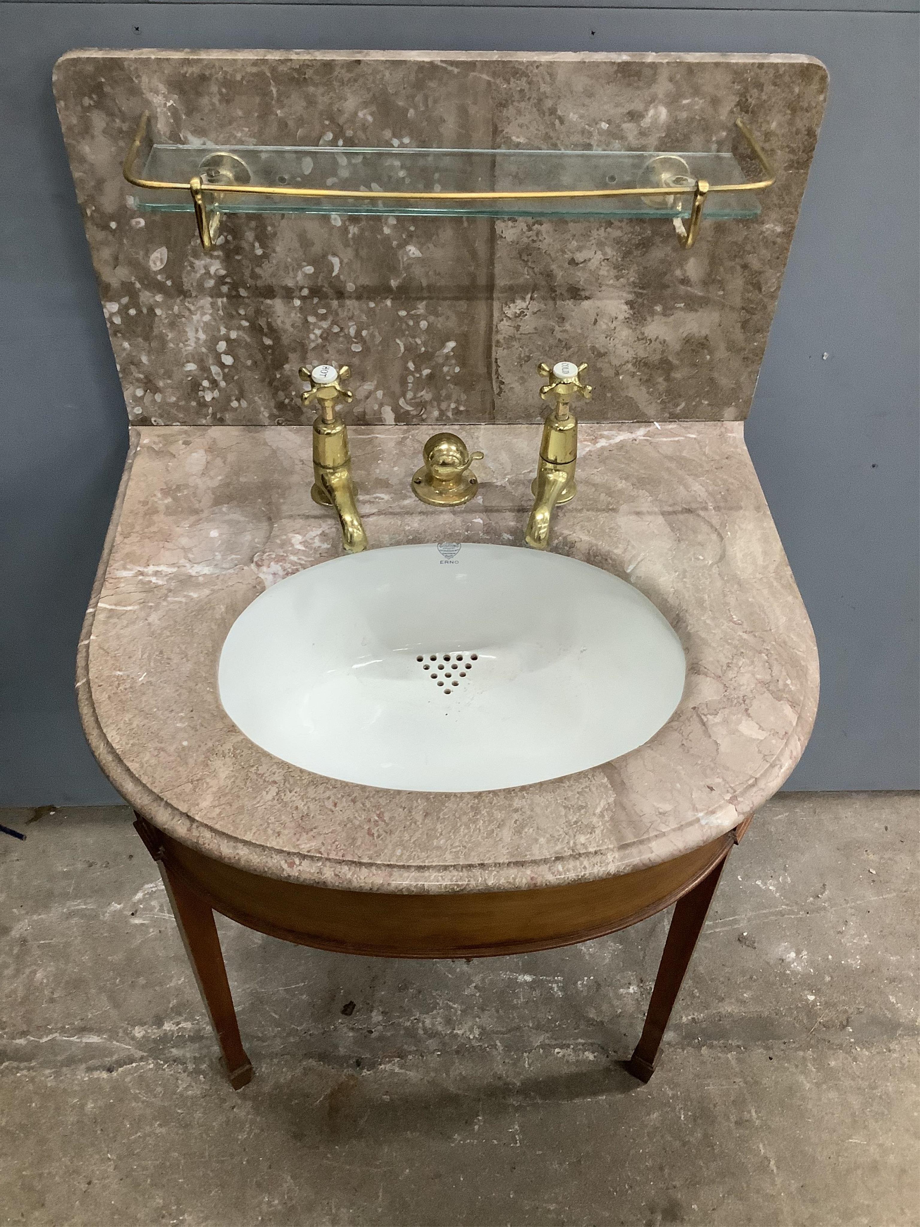 A marbled topped mahogany wash basin with John Bolding & Sons Erno ceramic basin and brass metal work, width 69cm, height 117cm. Condition - two old repair cracks to the marble top near front right, otherwise fair